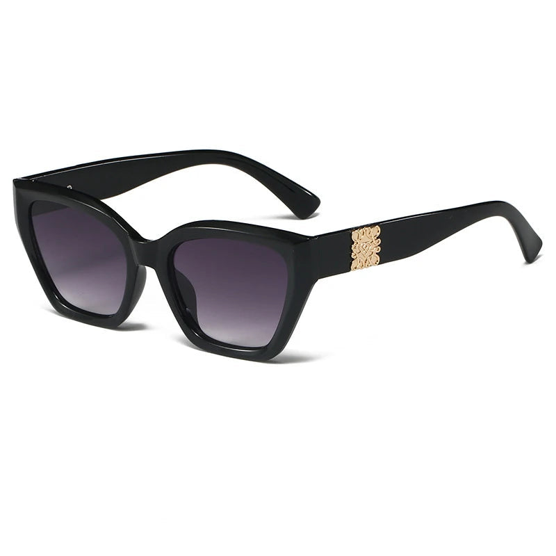 Black sunglasses with gold accents on a white background