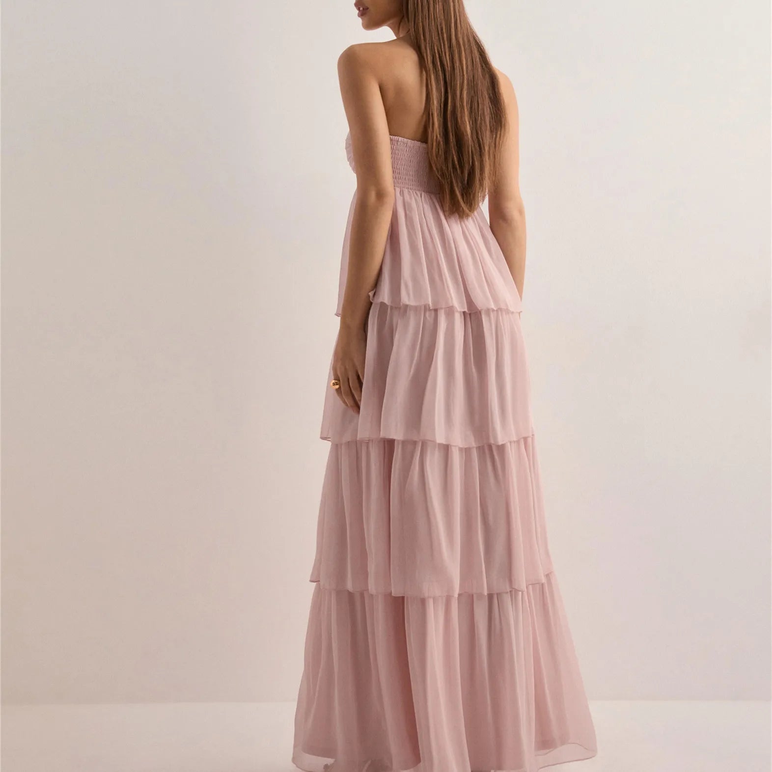 Bodice and bust detail of Jenny strapless tiered dress on model