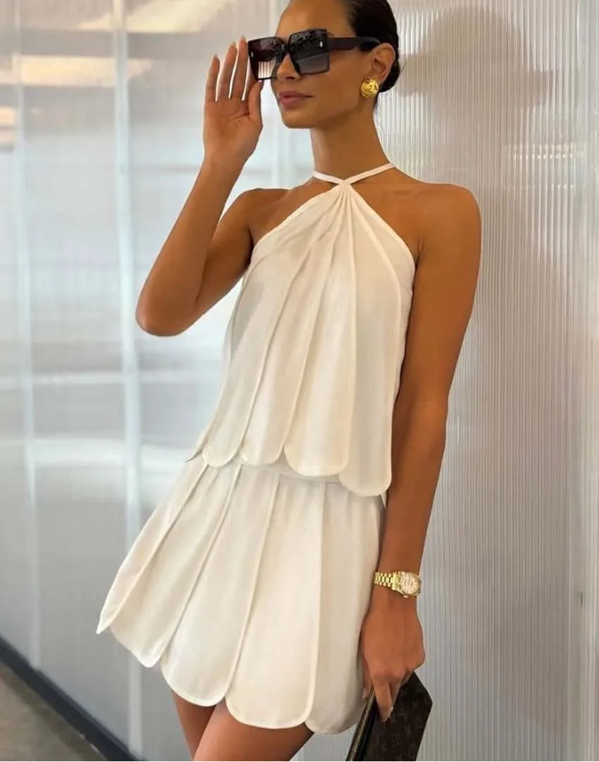 Woman wearing a white dress with sunglasses indoors