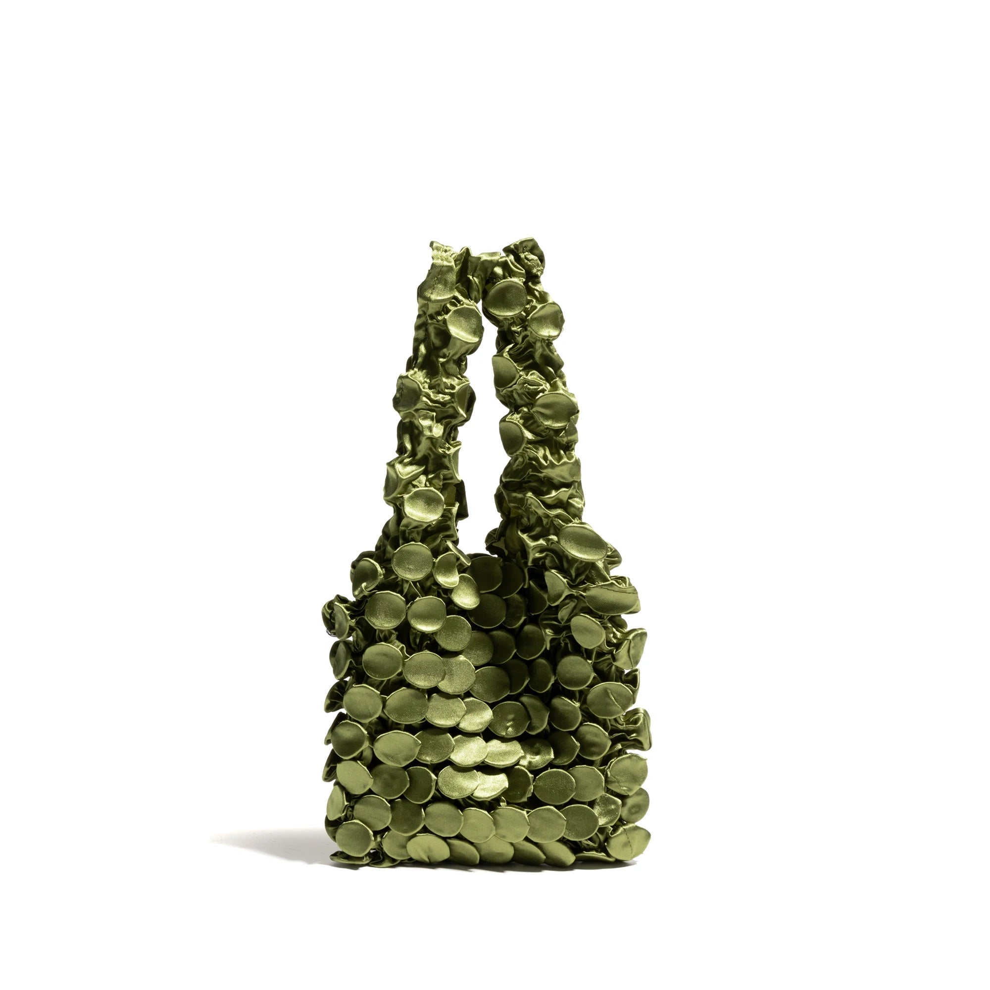 Green handbag with circular patterns on a white background