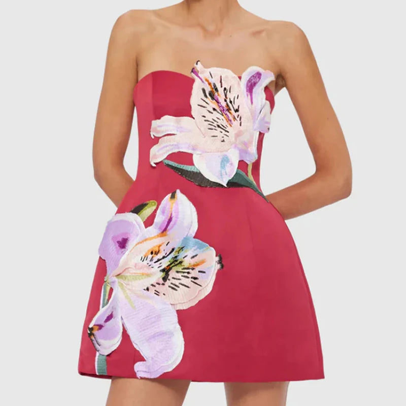 Red strapless dress with floral design on a white background
