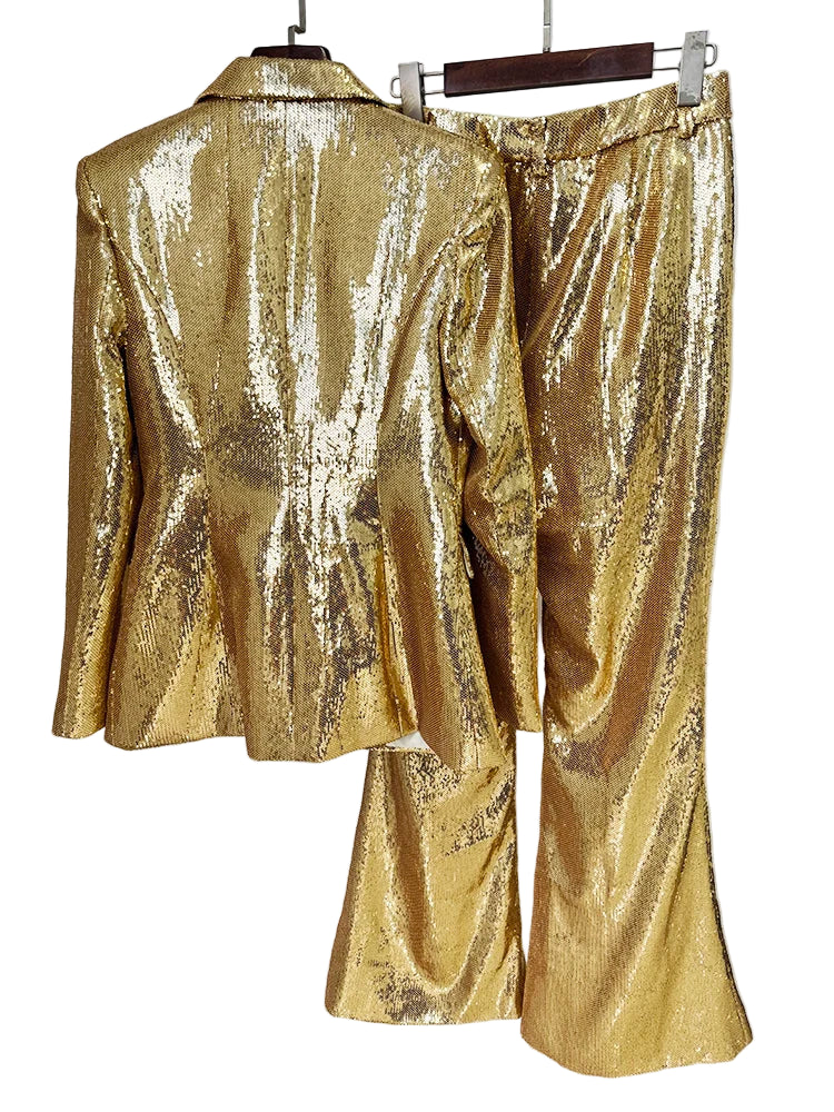 Gold sequin suit on a hanger against a white background