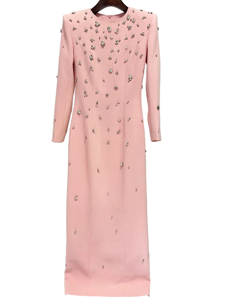 Pink dress with floral embellishments on a hanger against a white background