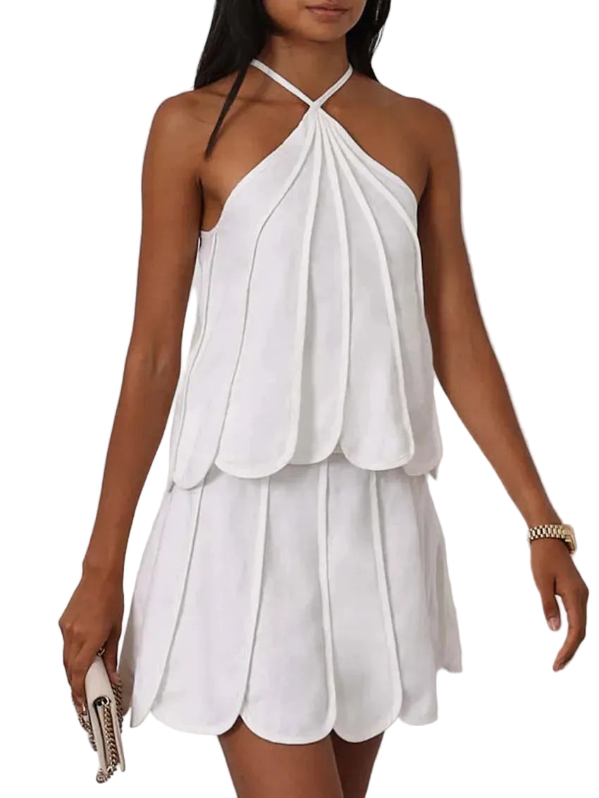 White halter neck dress worn by a model on a plain background