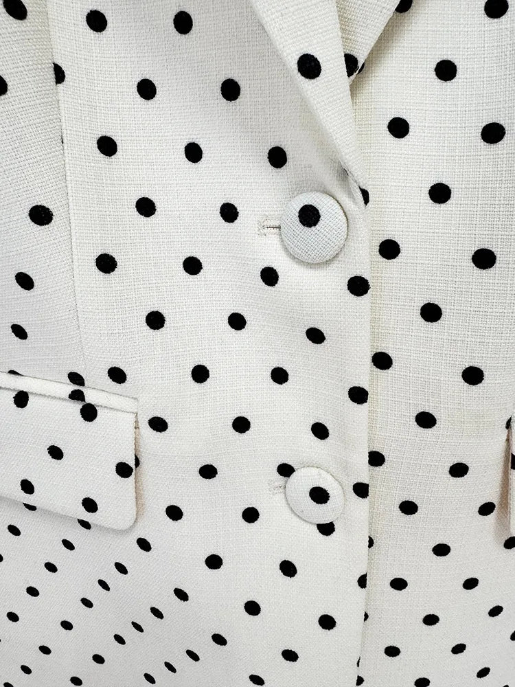 Close-up of a white shirt with black polka dot pattern