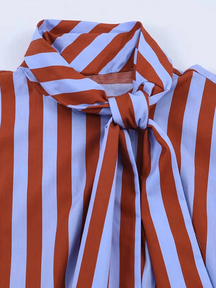 Close-up of a striped fabric with red and white vertical stripes on a blue background