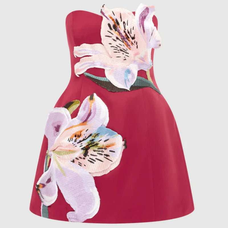 Red strapless dress with floral designs on a light gray background